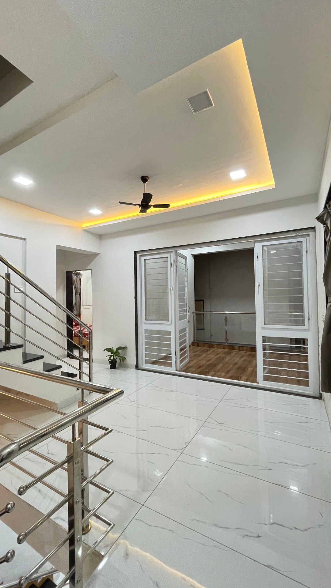 Saanjh villa first floor foyer with cove lighting and balcony